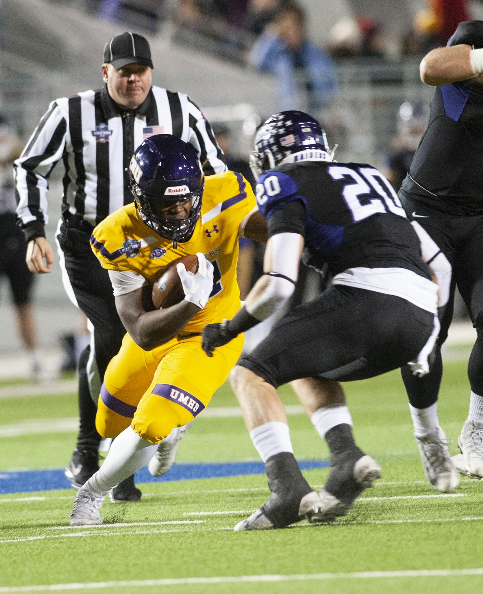 Dynamic college football game with athletes in action on the field, showcasing strategy and teamwork.